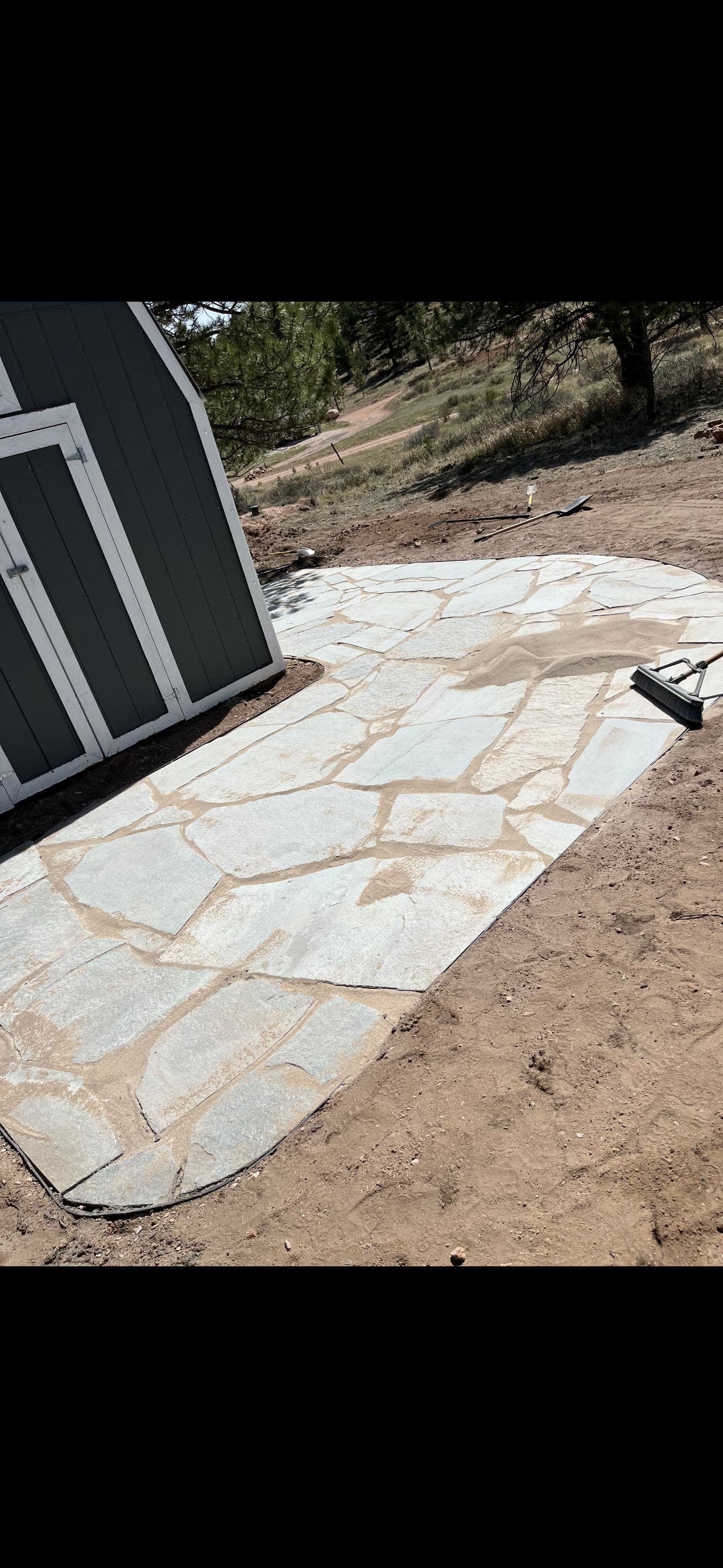 350 sq ft flagstone patio built to handle hillside drainage image