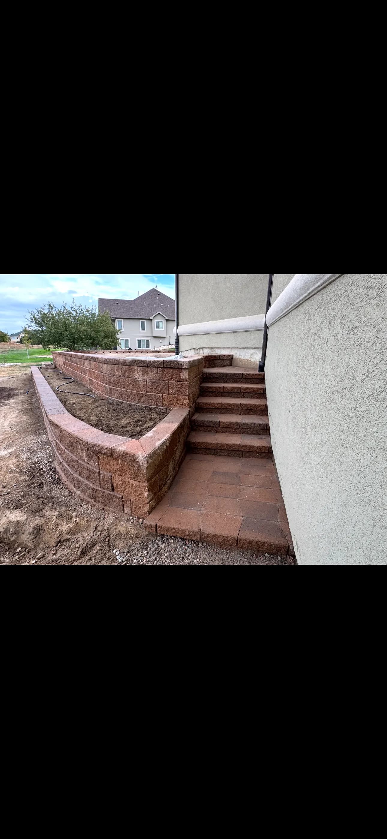 Tiered Retaining Wall with Paver Steps Built to Last image